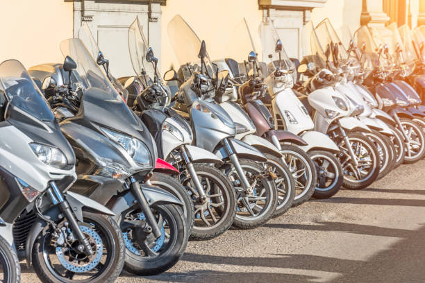 ligne de scooters pour vente et location dans les rues. - location vélo photos et images de collection
