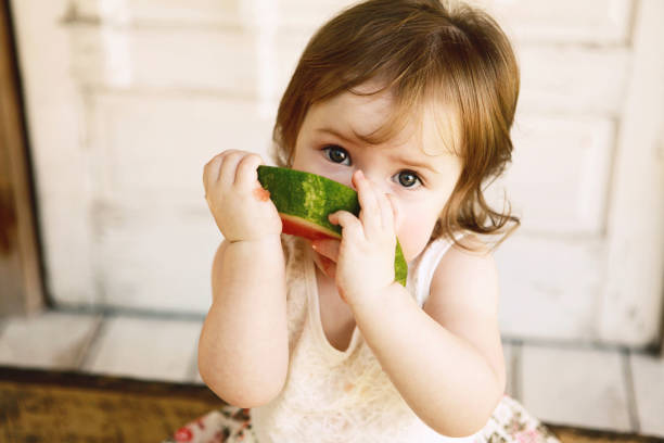 istock Little Girl Eating Watermelon 1125967588
