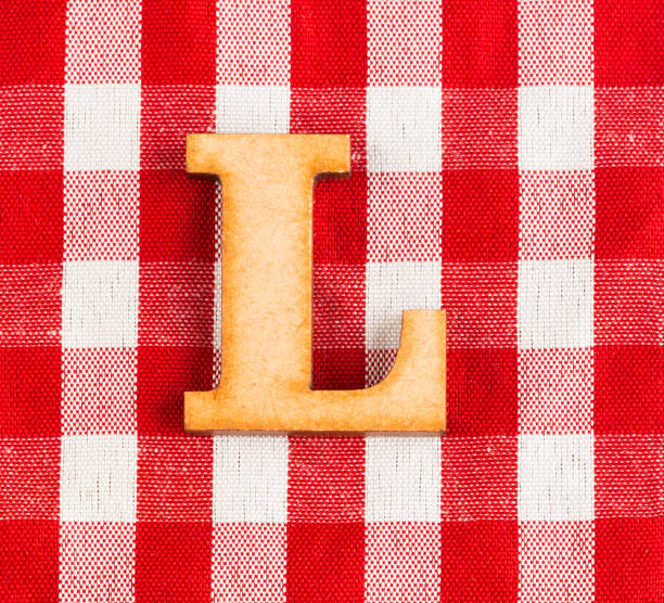 istock Letter L of the alphabet - Red checkered fabric tablecloth. 1125968464