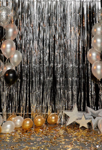 istock Silver festive background with balloons, stars and confetti illuminated by colored lanterns 1125968648