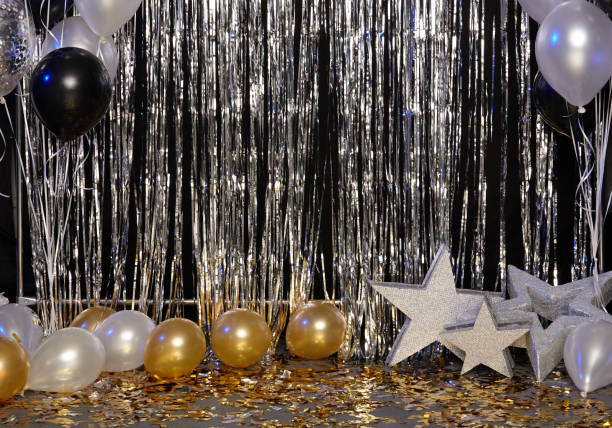 istock Silver festive background with balloons, stars and confetti illuminated by colored lanterns 1125968658