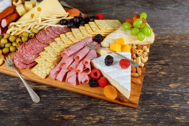 istock Beautiful collection set decor green olives, figs, nuts and berries on fresh assorted cheese composition 1125969180