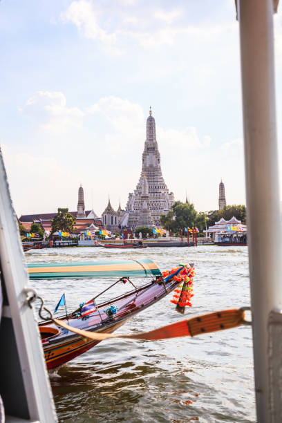 istock Thai riverside transportation in Chao Phraya River with Wat Arun (Buddhist Temple of Dawn) background, Bangkok. Traditional Thailand Tourist Attraction, Asia Cultural Travel, River Cruise concept 1125970540