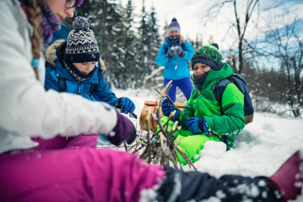 Mother and kids camping in winter forest