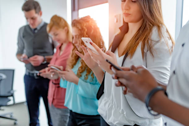 istock Group of people using their smartphones 1125971317