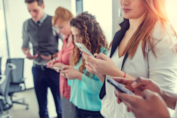 istock Group of people using their smartphones 1125971387