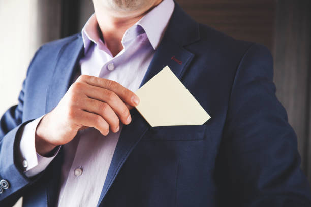istock businessman showing white card in pocket 1125971920