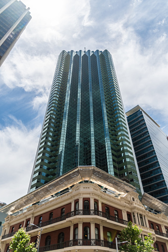 Old Victorian brick building in front of modern highrise skyscraper in Perth Western Australia