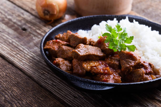 istock Beef stew served with white rice in cast iron skillet 1125972018