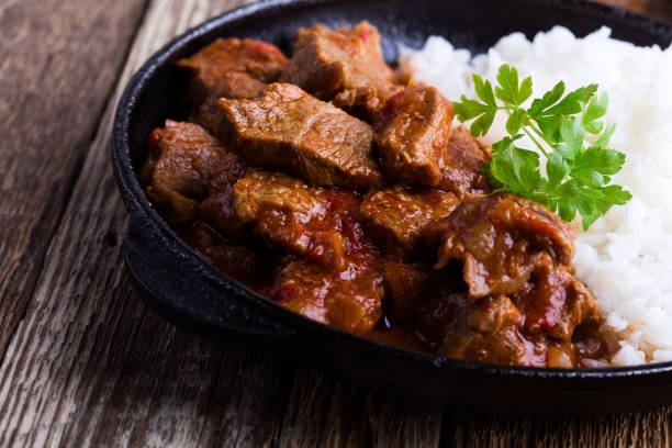 istock Beef stew served with white rice in cast iron skillet 1125972020