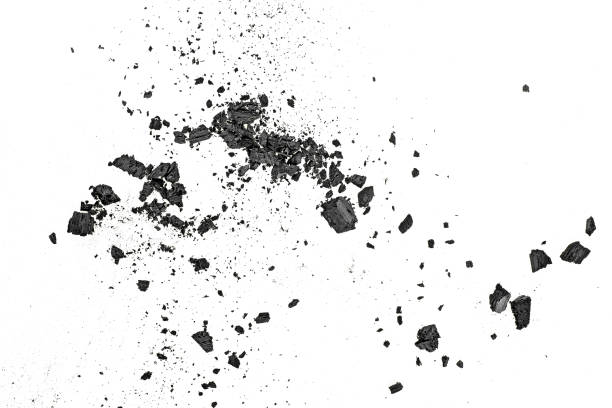 istock Small pieces of charcoal dust on white background, top view. 1125980303