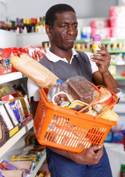 istock Ordinary mature African man holding spice packs 1125980839