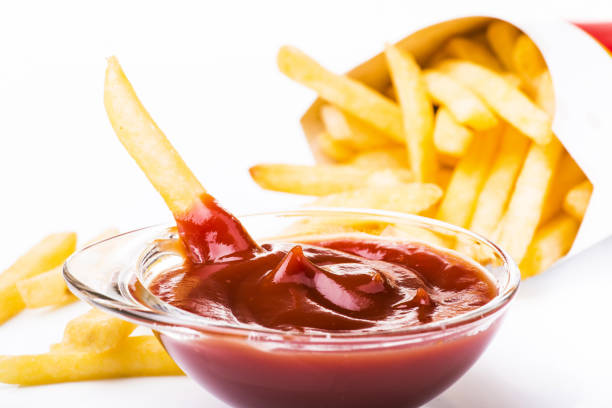 meal with ketchup and fries bowl with tomato sauce and fried potatoes isolated from the white background alimentazione non salutare stock pictures, royalty-free photos & images