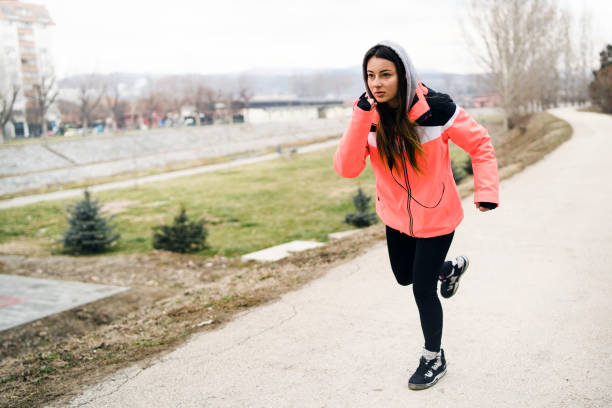 istock Young woman Running in winter day 1125982239