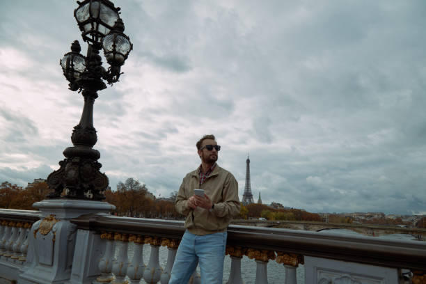 istock Modern man using cellphone in European city. 1125983225