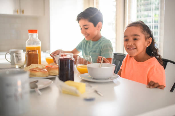 istock Brother and sister having breakfast at home 1125983272