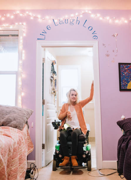 cheerful woman in wheelchair takes selfie in her home - motorized wheelchair audio imagens e fotografias de stock