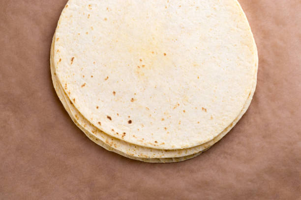 istock Tortilla on wrapping paper. Several Mexican tortilla on the table. 1125984816