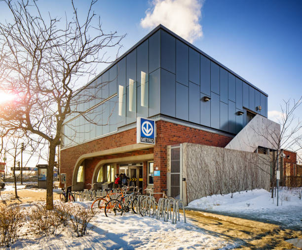 Montreal Namur metro subway station in Winter Montreal Namur metro subway station in Winter, with people entering the station and bicycles parked in front of it. montreal underground city stock pictures, royalty-free photos & images