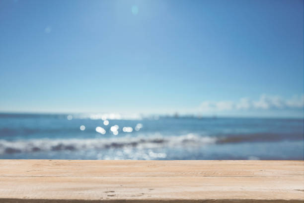 istock Empty Wooden Planks with Blur Beach on Background 1125987074