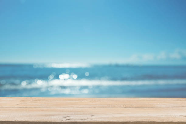 istock Empty Wooden Planks with Blur Beach on Background 1125987078