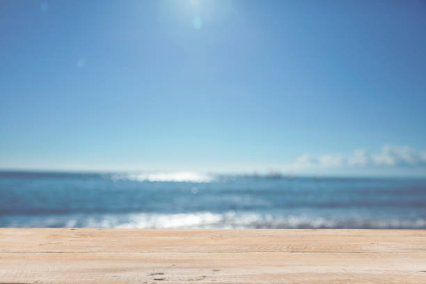 istock Empty Wooden Planks with Blur Beach on Background 1125987085