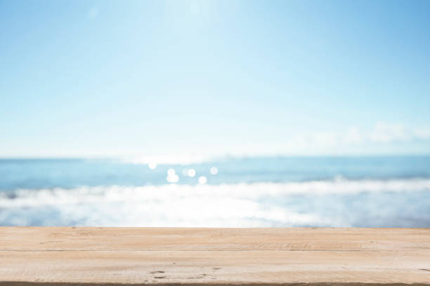 Empty Wooden Planks with Blur Beach on Background Empty Wooden Planks with Blur Beach on Background beaches stock pictures, royalty-free photos & images