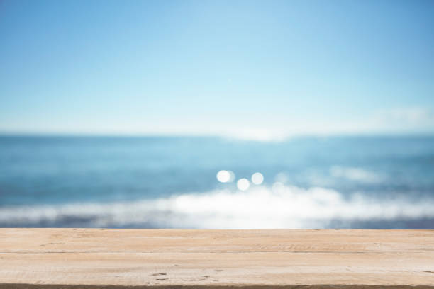 istock Empty Wooden Planks with Blur Beach on Background 1125987105
