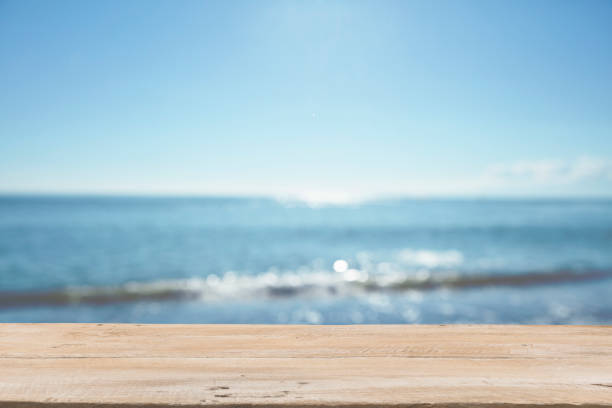 istock Empty Wooden Planks with Blur Beach on Background 1125987110