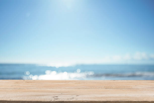 istock Empty Wooden Planks with Blur Beach on Background 1125987173