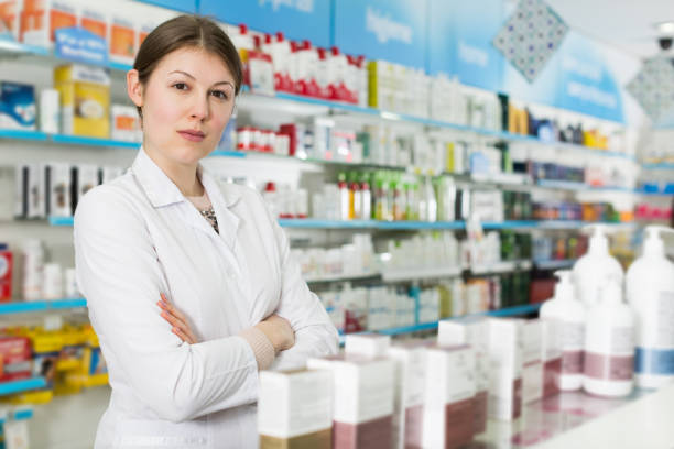 istock pharmacist standing with arms crossed in pharmacy 1125992940