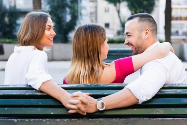 image of the love triangle between young people outdoor. - disaffection imagens e fotografias de stock