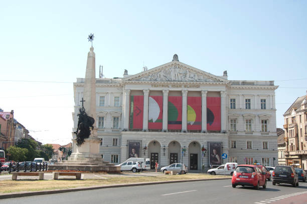 Arad, Romania - 11 July 2017 : The building of Ioan Slavici Classical Theatre and Holy Trinity monument