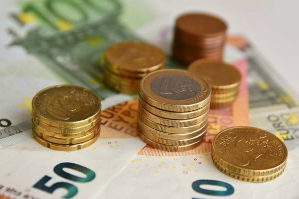 istock Euro bills and coins 1125994245