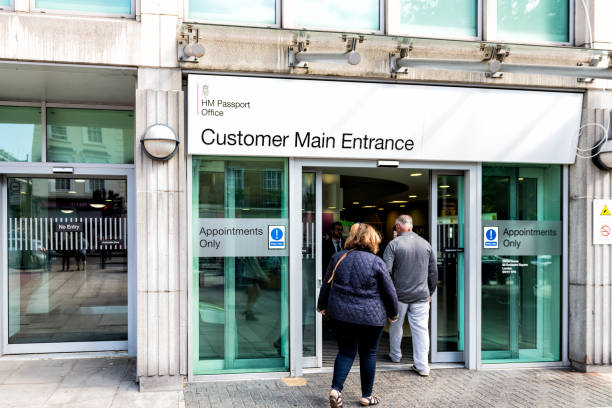 Sign on building near Victoria Station for HM Her Majesty's Passport Office Appointments and Collections and people walking inside entrance London, UK - September 15, 2018: Sign on building near Victoria Station for HM Her Majesty's Passport Office Appointments and Collections and people walking inside entrance hm government stock pictures, royalty-free photos & images