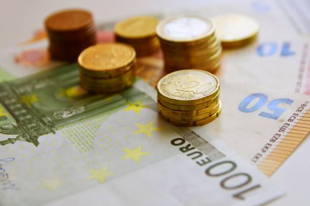 istock Euro bills and coins 1125994556