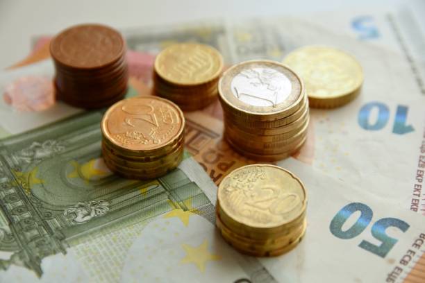 istock Euro bills and coins 1125994563