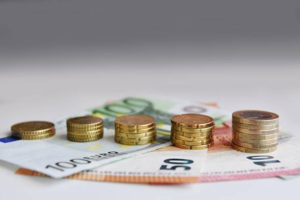 istock Euro bills and coins 1125994600