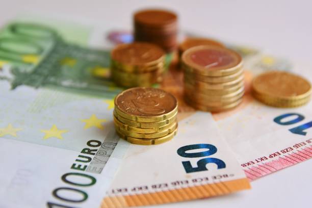 istock Euro bills and coins 1125994626