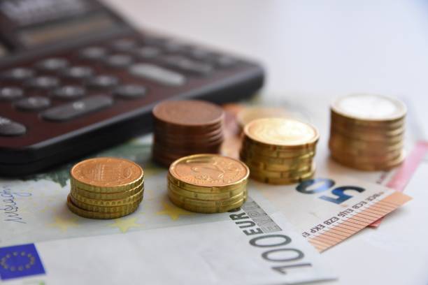 istock Euro bills and coins 1125994636