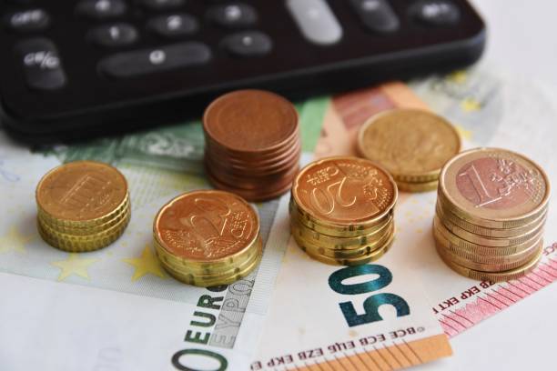 istock Euro bills and coins 1125994638