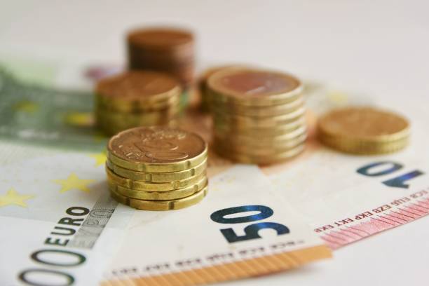 istock Euro bills and coins 1125994700