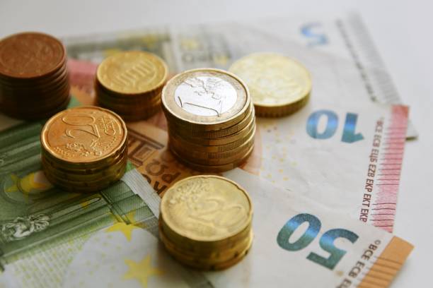 istock Euro bills and coins 1125994723