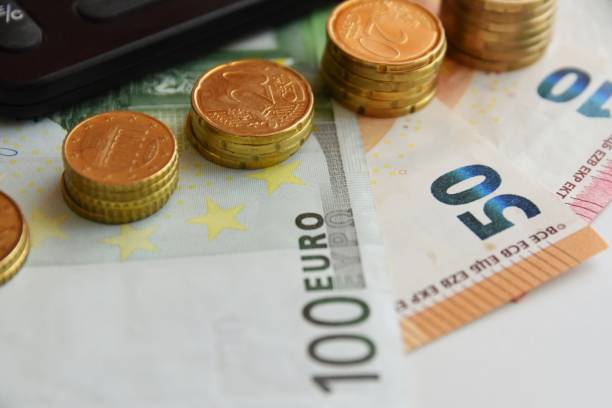 istock Euro bills and coins 1125994739