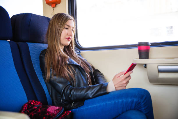 istock Girl using smart phone while travelling on the train 1125996022