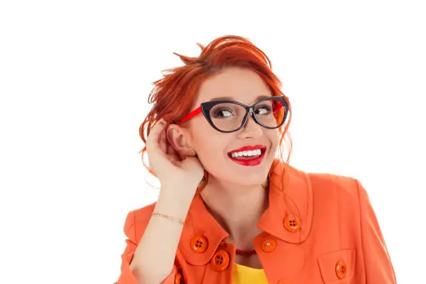 Photo of funny curious woman holding palm near ear listening gossips eavesdropping