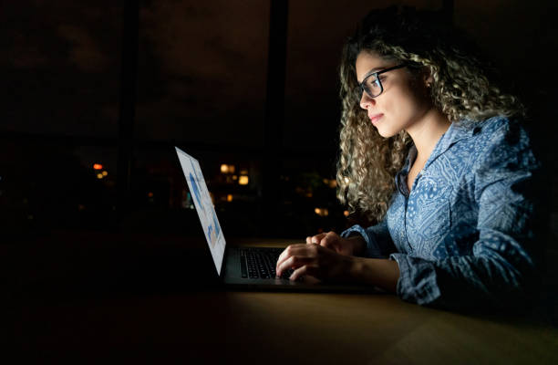 istock Woman working online from home at nighttime 1125999596