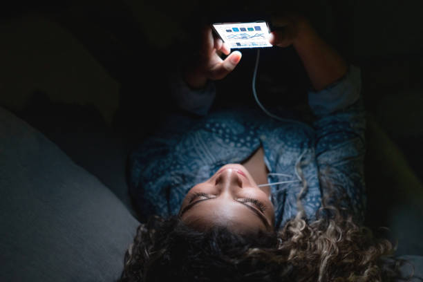 istock Woman at home using app on her cell phone while relaxing at nighttime 1125999606