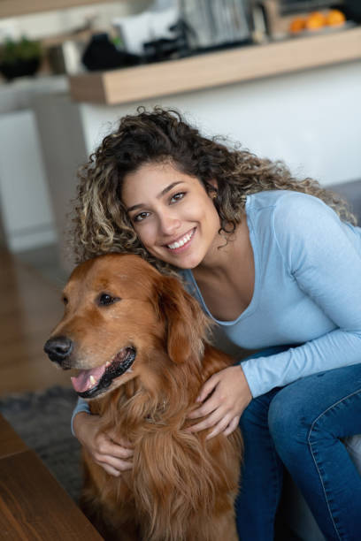 istock Young woman at home hugging her dog 1125999613