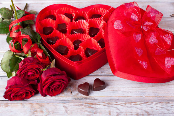 istock Heart chocolate box and red roses on wooden rustic background 1126000793